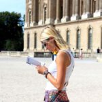 Tourist Map - woman in white tank top holding white book