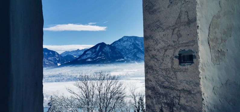 Creepy Castle - a view of mountains from a window in a building